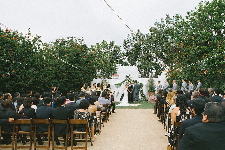 Wide shot of an outdoor wedding ceremony in a garden