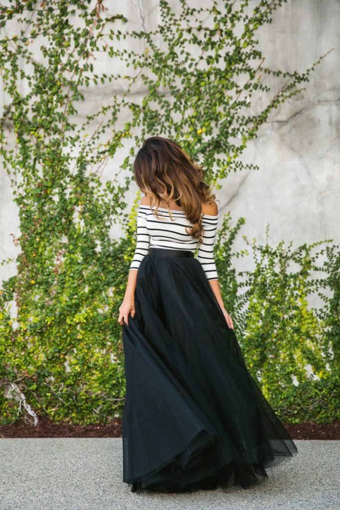 woman in black long tulle skirt and a black and white striped long sleeved top
