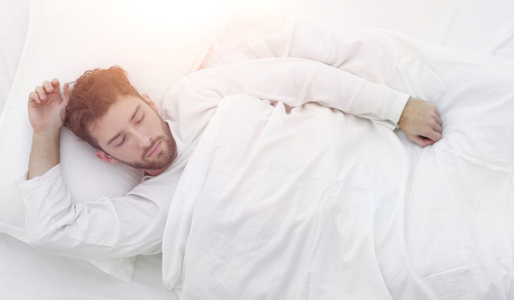 Man sleeping with a weighted blanket